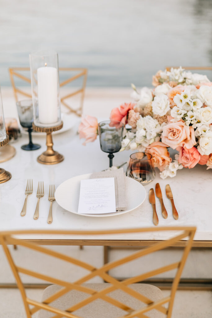 Intimate dinner setup on a private villa’s dock in Croatia, with elegant white linens and guests enjoying a sunset meal beside the Adriatic Sea.