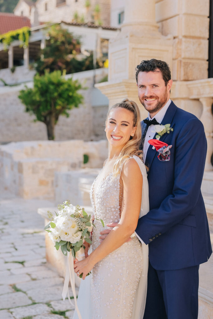 The bride and groom exchanging vows inside the historic St. Stephan Cathedral in Hvar, surrounded by soft candlelight and elegant floral arrangements.