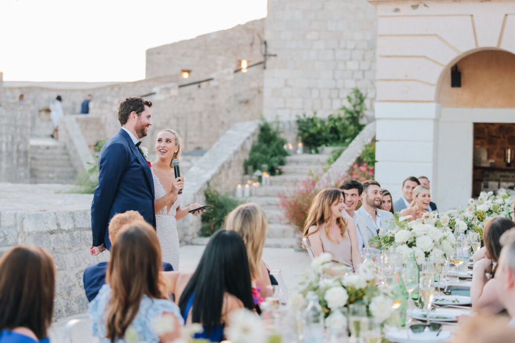 A scenic view of Hvar’s rugged coastline with turquoise waters and sailboats dotting the horizon — the perfect destination wedding backdrop.