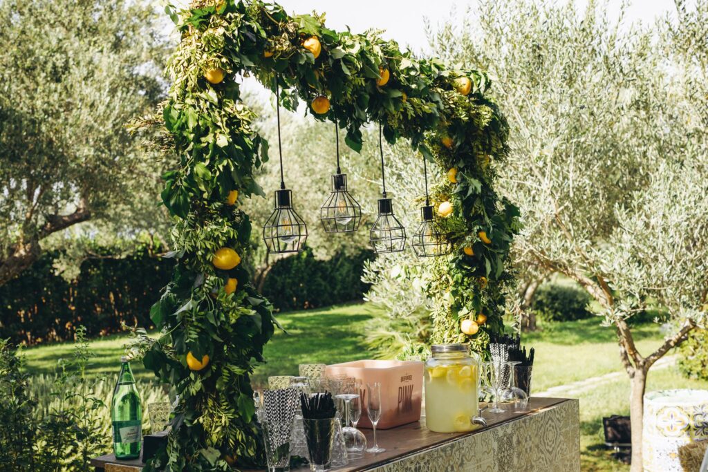 Stunning outdoor event venue by the Adriatic Sea, surrounded by lush greenery and lemon-themed decorations.
