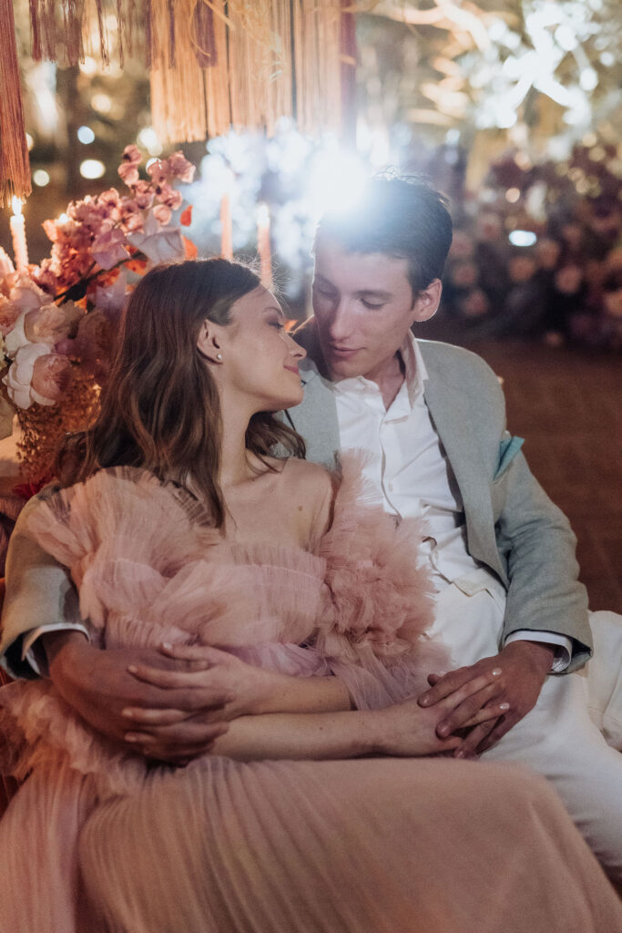 Charming wedding reception under olive trees at Maslina Resort, beautifully adorned with handmade ceramic plates and floral decor