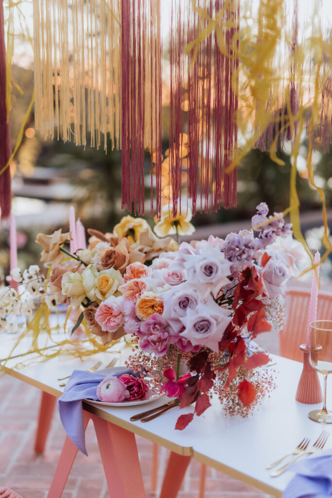 Charming wedding reception under olive trees at Maslina Resort, beautifully adorned with handmade ceramic plates and floral decor