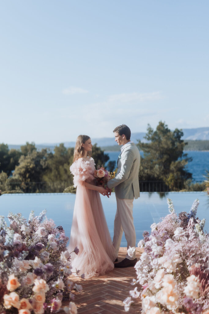 Elegant wedding ceremony setup at Maslina Resort, featuring pastel-colored floral arrangements and the crystal-clear Adriatic waters in the background