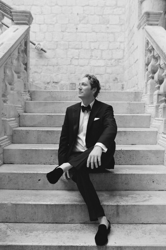 Morgan and Robbie’s three-day Dubrovnik wedding with a Hilton welcome dinner, Banje Beach party, and St. Lawrence Fortress ceremony, featuring signature cocktails, vintage bells, drummers, and a lively French band.