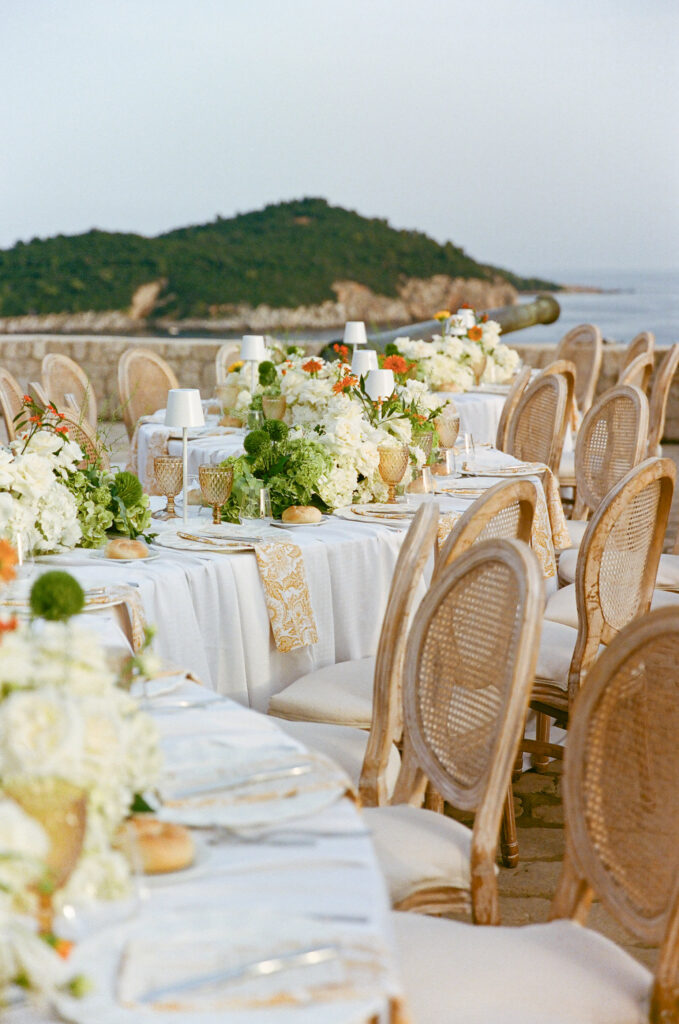 Morgan and Robbie’s three-day Dubrovnik wedding with a Hilton welcome dinner, Banje Beach party, and St. Lawrence Fortress ceremony, featuring signature cocktails, vintage bells, drummers, and a lively French band.