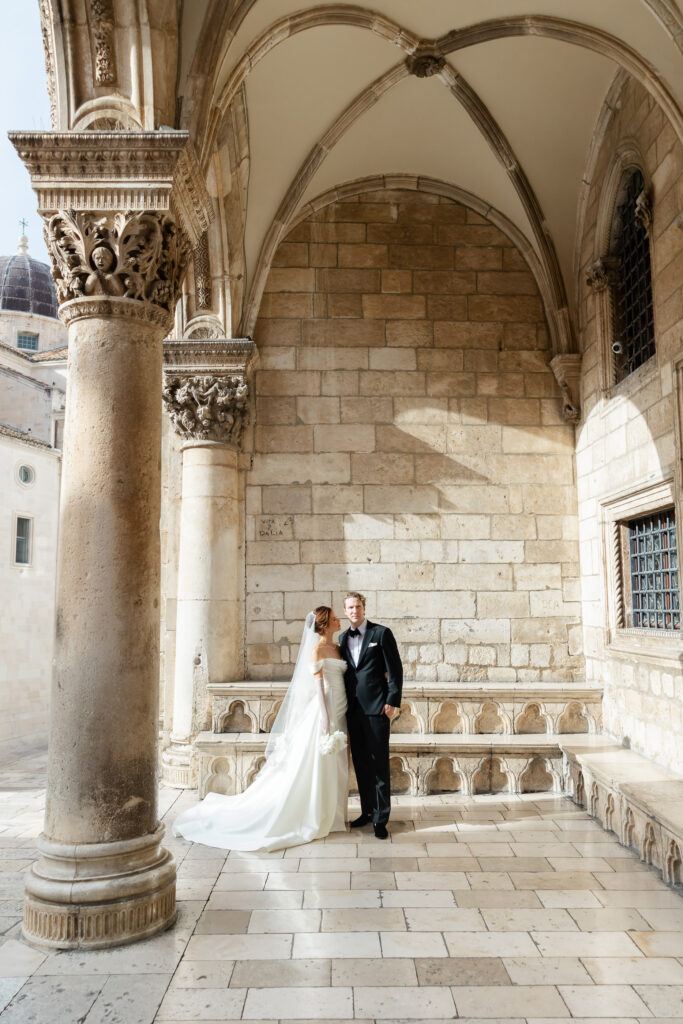 Morgan and Robbie’s three-day Dubrovnik wedding with a Hilton welcome dinner, Banje Beach party, and St. Lawrence Fortress ceremony, featuring signature cocktails, vintage bells, drummers, and a lively French band.