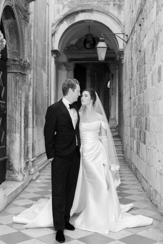 Morgan and Robbie’s three-day Dubrovnik wedding with a Hilton welcome dinner, Banje Beach party, and St. Lawrence Fortress ceremony, featuring signature cocktails, vintage bells, drummers, and a lively French band.