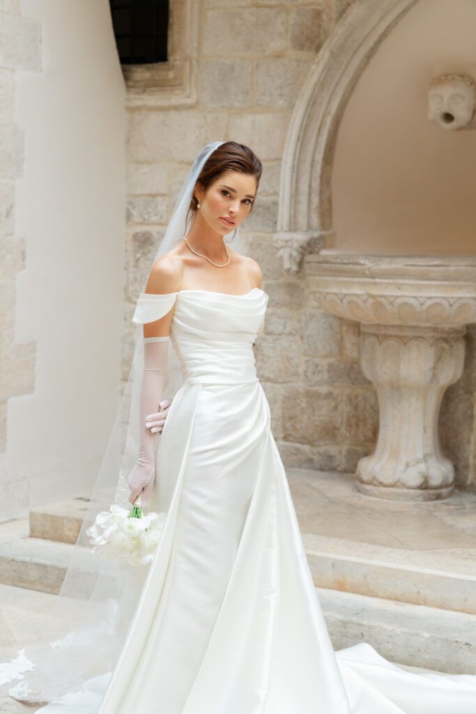 Morgan and Robbie’s three-day Dubrovnik wedding with a Hilton welcome dinner, Banje Beach party, and St. Lawrence Fortress ceremony, featuring signature cocktails, vintage bells, drummers, and a lively French band.