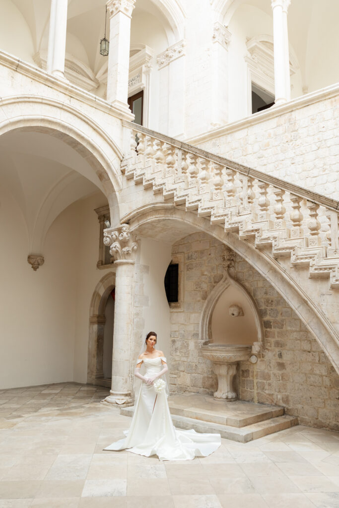 Morgan and Robbie’s three-day Dubrovnik wedding with a Hilton welcome dinner, Banje Beach party, and St. Lawrence Fortress ceremony, featuring signature cocktails, vintage bells, drummers, and a lively French band.