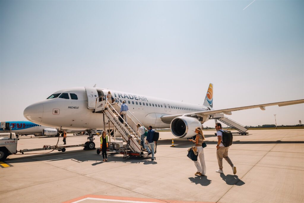 Guests boarding private plane for surprise destination wedding in Croatia