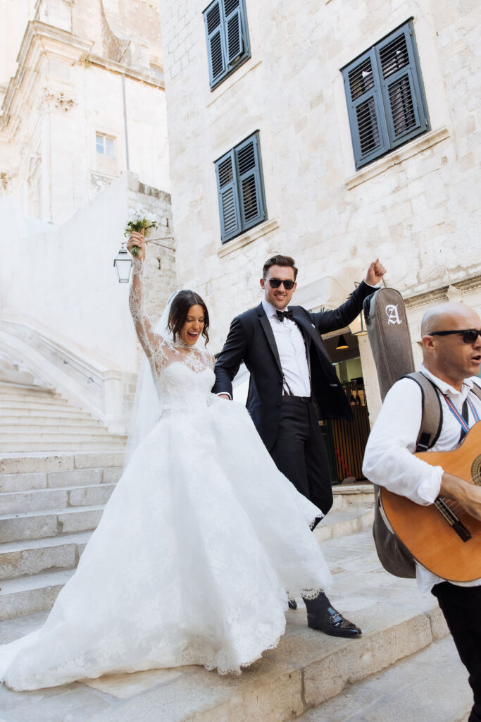 Walking down famous Dubrovnik stairs at St. Ignatius church at Dubrovnik Julia & Jacob MOMA wedding