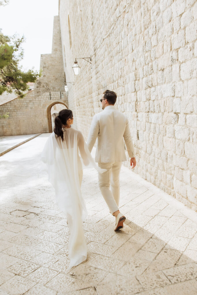 Wedding Couple walking in Dubrovnik to their reception at MOMA venue